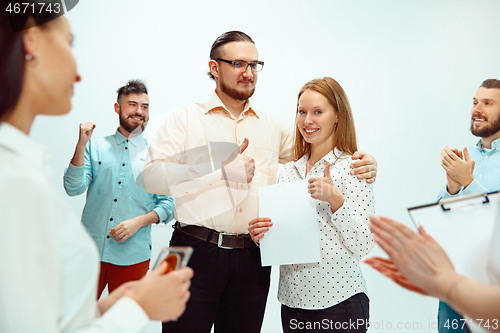 Image of Boss approving and congratulating young successful employee