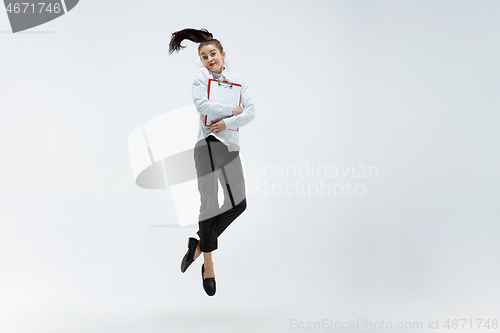 Image of Happy business woman dancing and smiling isolated on white.