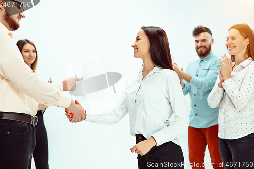 Image of Boss approving and congratulating young successful employee