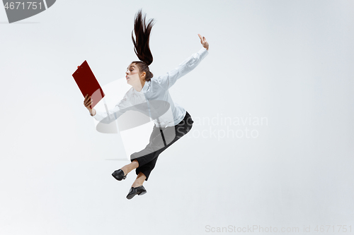 Image of Happy business woman dancing and smiling isolated on white.