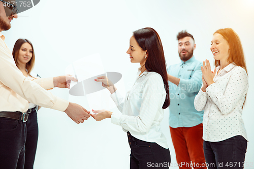 Image of Boss approving and congratulating young successful employee