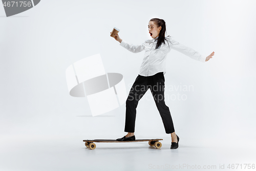 Image of businesswoman riding skate on white background