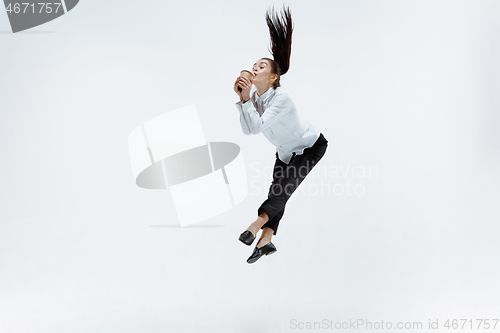 Image of Happy business woman dancing and smiling isolated on white.