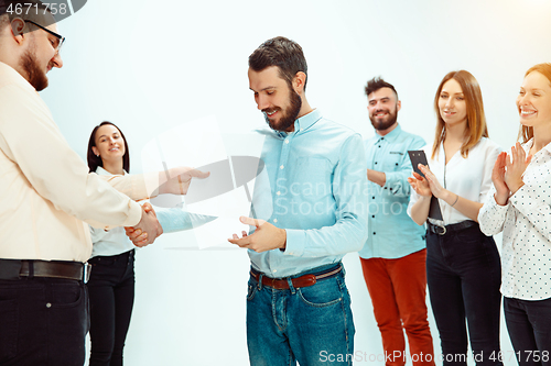 Image of Boss approving and congratulating young successful employee