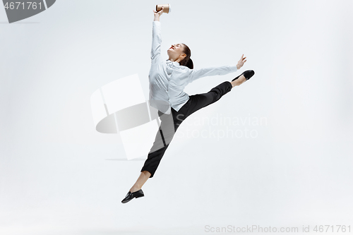 Image of Happy business woman dancing and smiling isolated on white.