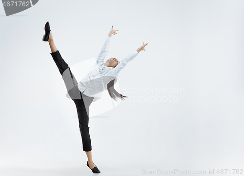 Image of Happy business woman dancing and smiling isolated on white.