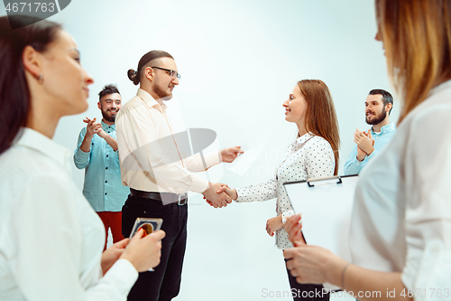 Image of Boss approving and congratulating young successful employee