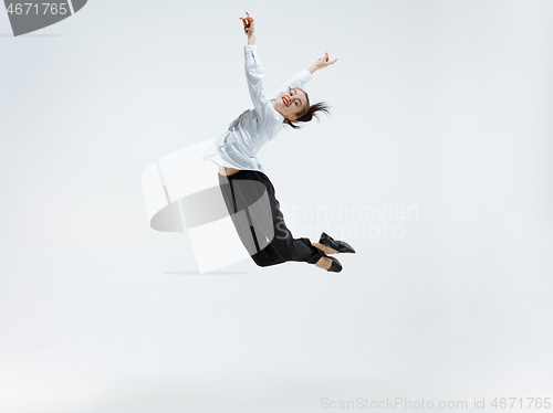 Image of Happy business woman dancing and smiling isolated on white.