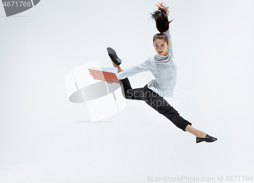 Image of Happy business woman dancing and smiling isolated on white.