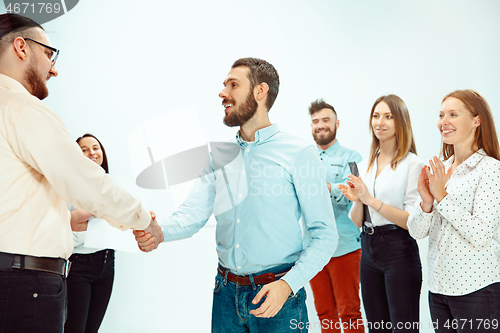 Image of Boss approving and congratulating young successful employee