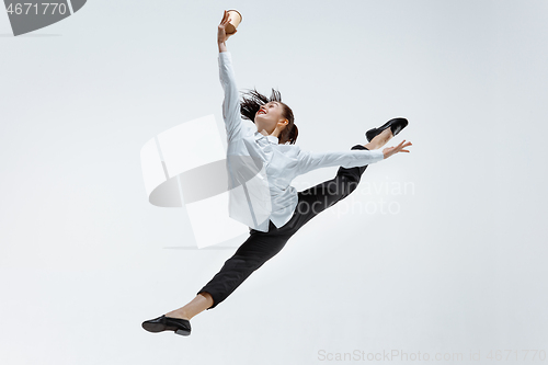 Image of Happy business woman dancing and smiling isolated on white.