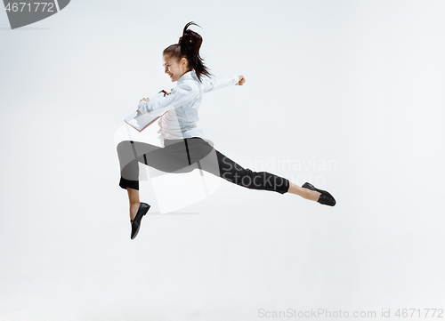 Image of Happy business woman dancing and smiling isolated on white.
