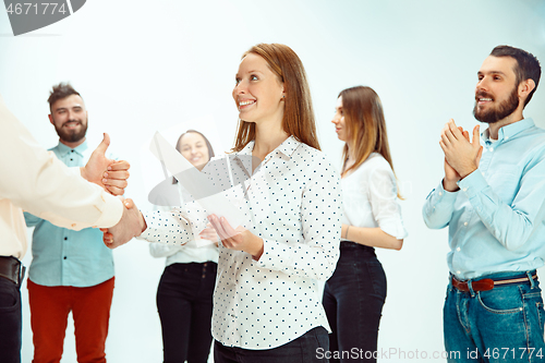 Image of Boss approving and congratulating young successful employee