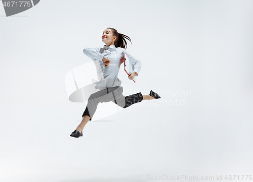 Image of Happy business woman dancing and smiling isolated on white.