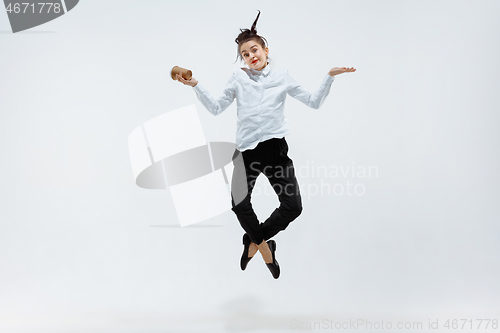 Image of Happy business woman dancing and smiling isolated on white.