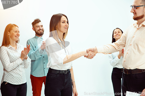 Image of Boss approving and congratulating young successful employee