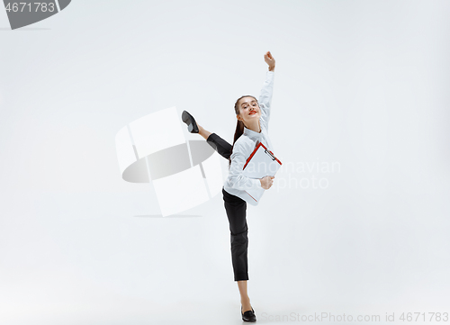 Image of Happy business woman dancing and smiling isolated on white.