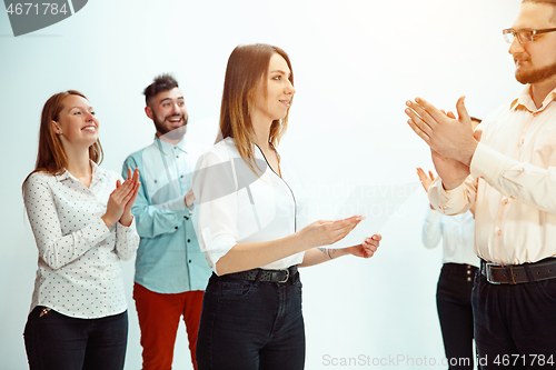 Image of Boss approving and congratulating young successful employee