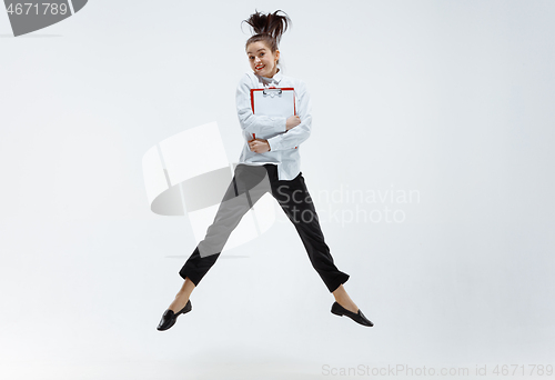 Image of Happy business woman dancing and smiling isolated on white.