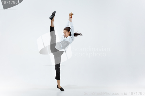 Image of Happy business woman dancing and smiling isolated on white.