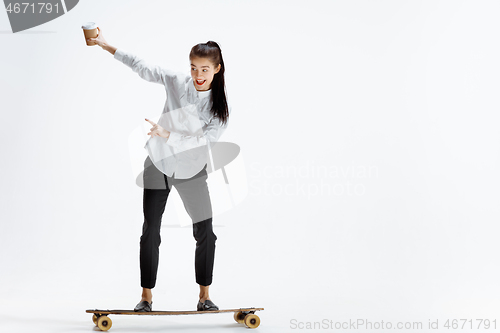 Image of businesswoman riding skate on white background