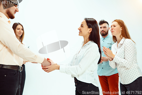 Image of Boss approving and congratulating young successful employee