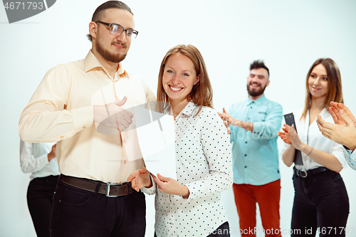 Image of Boss approving and congratulating young successful employee