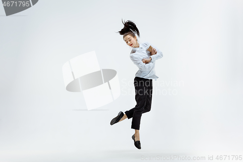 Image of Happy business woman dancing and smiling isolated on white.