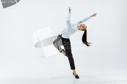 Image of Happy business woman dancing and smiling isolated on white.