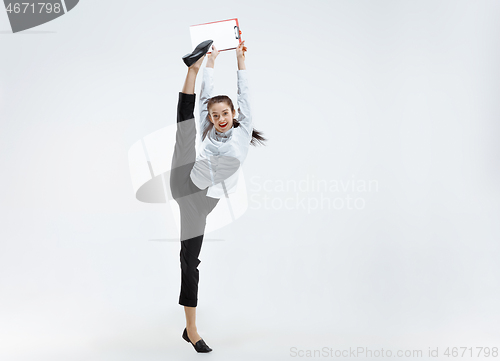 Image of Happy business woman dancing and smiling isolated on white.