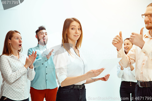 Image of Boss approving and congratulating young successful employee