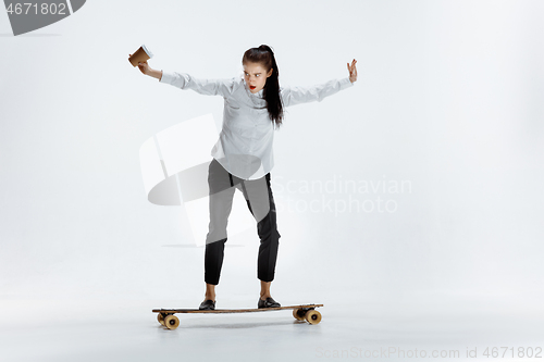 Image of businesswoman riding skate on white background