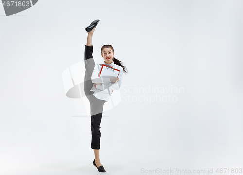 Image of Happy business woman dancing and smiling isolated on white.