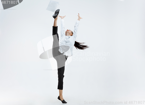 Image of Happy business woman dancing and smiling isolated on white.