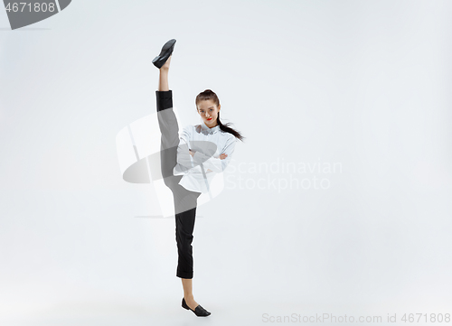 Image of Happy business woman dancing and smiling isolated on white.