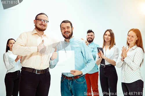 Image of Boss approving and congratulating young successful employee