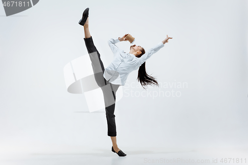 Image of Happy business woman dancing and smiling isolated on white.