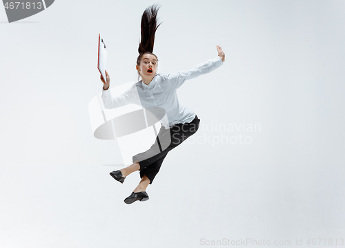 Image of Happy business woman dancing and smiling isolated on white.