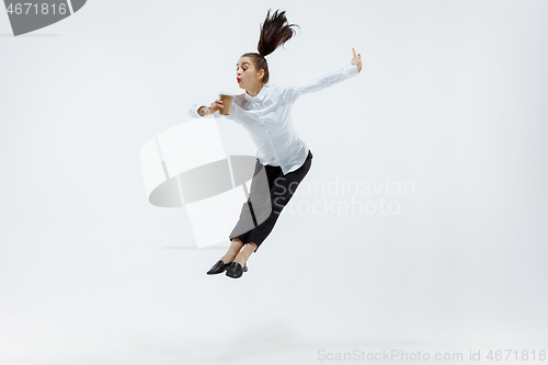 Image of Happy business woman dancing and smiling isolated on white.