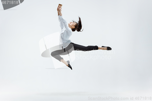 Image of Happy business woman dancing and smiling isolated on white.
