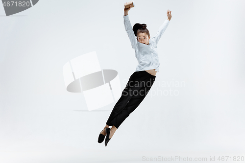 Image of Happy business woman dancing and smiling isolated on white.