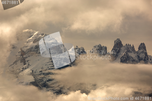 Image of Snow-capped alps mountains in clouds