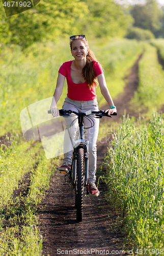 Image of Cute young girl on bicycle