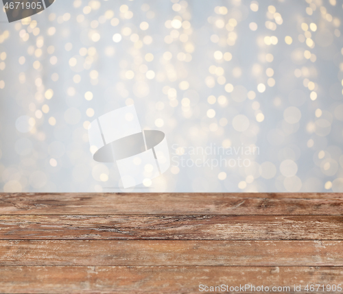 Image of empty wooden table with christmas golden lights