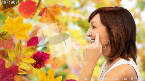 Image of profile of senior woman pointing to eye wrinkles