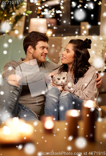 Image of happy couple with cat at home