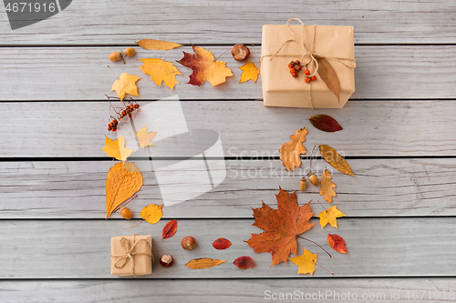 Image of frame of gifts, autumn leaves and rowanberry