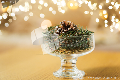 Image of christmas fir decoration with cone in dessert bowl