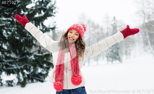 Image of happy young woman in winter park
