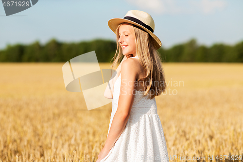 Image of portrait of girl in straw hat on field in summer